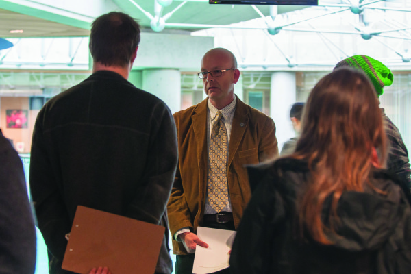 Students presented SFU's associate vice-president, student services, Tim Rahilly, with their petition in the halls of MBC. - Leah Bjornson